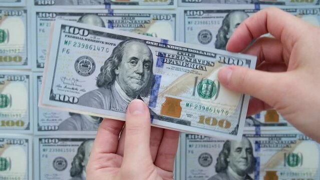 A lot of banknotes. Hundred American dollars banknotes, obverse side up, rotation on circle. Financial background. Selective focus. Top view. High quality FullHD footage with slow motion