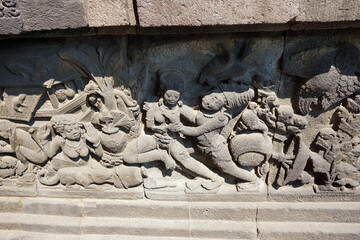 Close up of a stone bas relief on wall of the ancient Prambanan Temple with in Yogyakarta, Indonesia. No people.