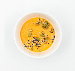 Hummus with seeds in a bowl on a white background. Top view, isolate