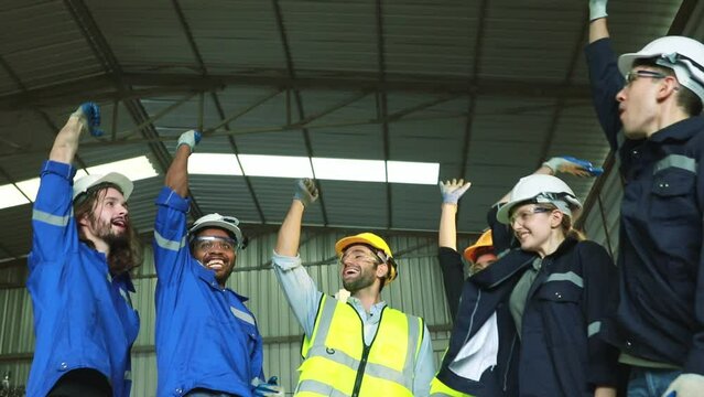 Unity of the engineering team and the worker team in the factory shop that join hands, both men and women, join forces to work for the industry to success. Teamwork and professional colleagues.