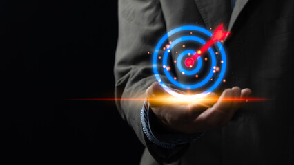 Businessman showing dart board and arrows with icons on hand virtual, business target planning...