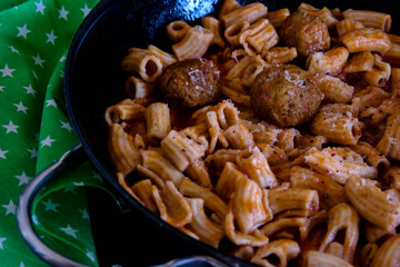 homemade pasta with meatballs in tomato sauce