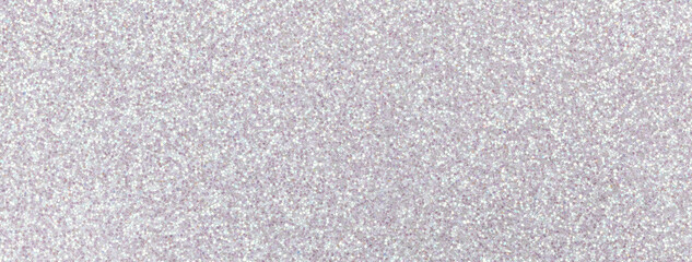 Light silver sparkling background from small sequins, macro. gray shiny backdrop with glitter pattern.