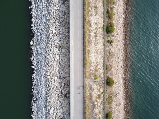 Ariel top down landscape photo of a road by the water, with distinct rock formation