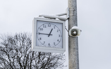 Train station clock timer and megaphone speaker. Time indication for passengers and loudspeaker on...