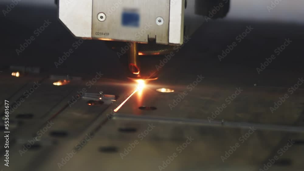 Poster automatic laser cutting machine slowly cutting part with holes with sparkling from the metal sheet d