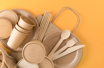 Paper utensils bundle, food packaging articles over orange background. Street food paper packaging,...