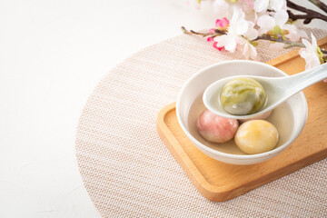 Colored glaze style big tangyuan with cherry blossom flower and syrup soup.