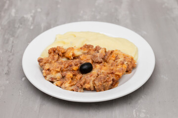 Minced meat and mashed potato on white plate