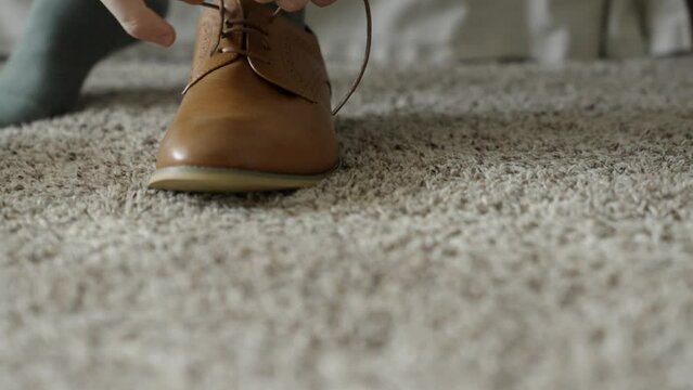 Groom tying his shoes. Groom getting ready on his wedding day. Tie the knot. Shot in 4K 60FPS for high quality slow motion. To purchase entire event raw at wholesale price email willneatheryyahoo.com.