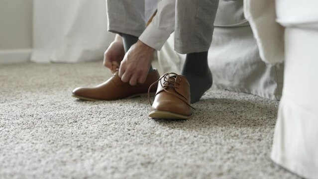 Groom tying his shoes on his wedding day. Groom tying his shoes. Shot in 4K 60FPS for high quality slow motion. To purchase entire event raw at wholesale price email willneatheryyahoo.com.