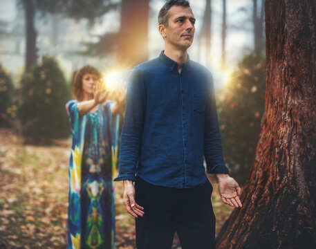 Man and woman heal each other with healing energy. Pranic healing.