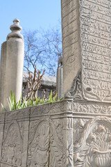 ancient tombstones with ruins on them inside local park on a clear sunny day 