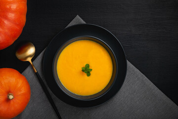 Vegetarian autumn pumpkin cream soup with seeds. Top view with copy space
