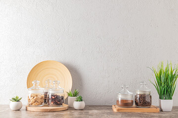 various kitchen utensils on a wooden countertop against the background of a gray textured wall. kitchen background for the layout with a copy space.