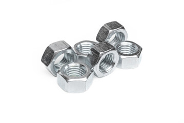 Set of steel nuts. On an isolated white background. With scratches. Close-up studio macro photography.