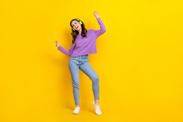 Fototapeta na wymiar Full length photo of excited cheerful person dancing enjoy listen favorite music isolated on yellow color background