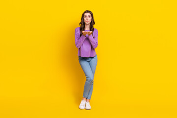 Full length photo of gorgeous young person arms palms send air kiss isolated on yellow color background