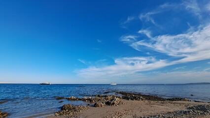 Beach and sea. Blue sky and white clouds
