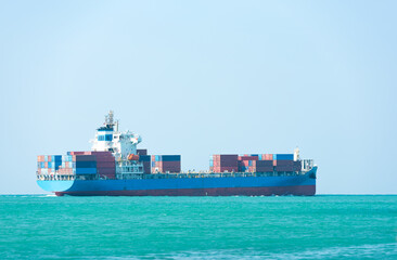 A cargo ship is traveling in the ocean.