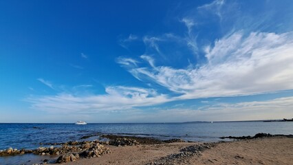 Fototapeta na wymiar Beach and sea. Blue sky and white clouds 
