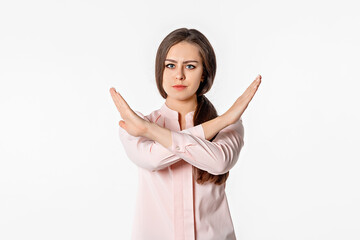 Portrait of brunette young woman hold hands crossed angry mood, standing over white studio...