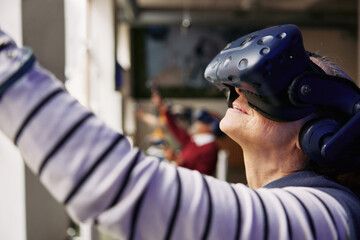 Smiling senior woman exploring a virtual world