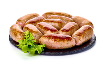 Grilled pork bangers on rustic slate stone plate, isolated on white background.