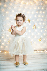 cute baby girl in a white and gold dress