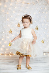 cute baby girl in a white and gold dress