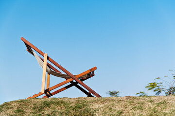 Deck chair on the meadow in the garden