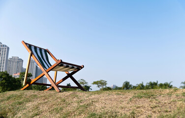 Deck chair on the meadow in the garden