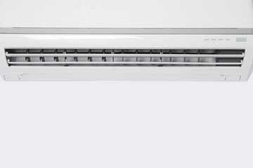 Modern air conditioner on white wall. Space for text