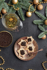 Black caviar appetizers stars on a christmas decorated black table