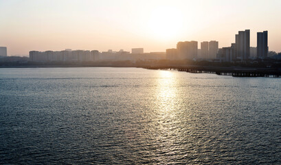 Fototapeta premium City by the sea at sunset