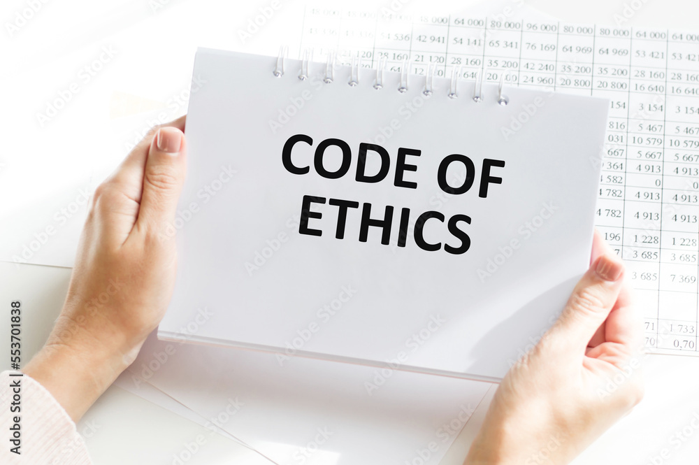 Aufkleber man hands holding tablet with text code of ethics at workplace. businessman working at desk with doc