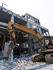 Excavator working on building demolition site