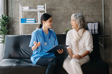 Kind nurse together with elderly woman in the hospital's