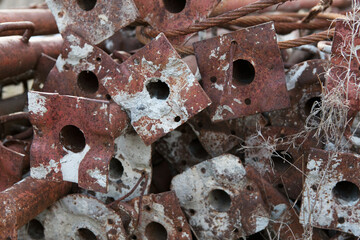 Rusty construction scaffolding stacked unused.