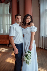 Bride and groom. Portrait of a man and a woman in a white vintage dress in a classic interior on a wedding day. Wedding day