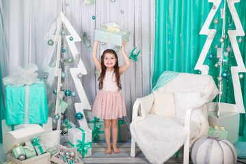 Girl in a stylish living room with turquoise / tiffany Christmas interior