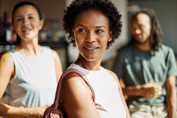 Smiling woman hanging out with friends after a workout