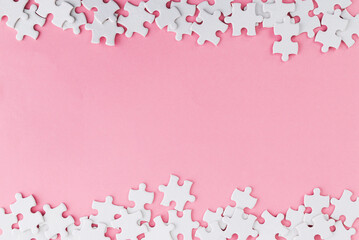 Pieces of jigsaw puzzle on pink background