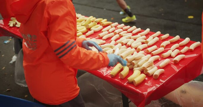 High angle view of rows of fresh bananas prepared on table in refreshment station. Marathon run race, Berlin, Germany