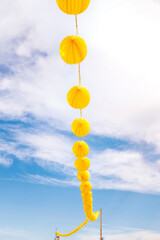 Yellow paper lanterns hanging on a wire
