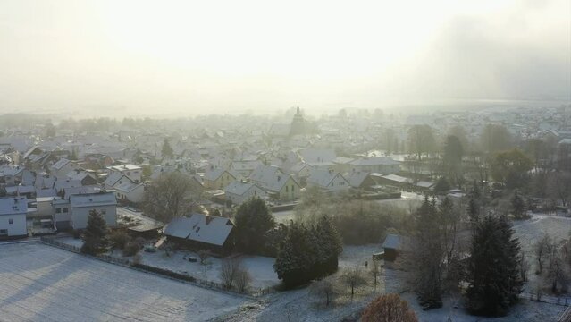 Cinematic Aerial Drone Shot of Komturkirche in Butzbach Germany covered in Snow