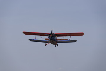 AIRPLANE - The biplane flies against  blue sky