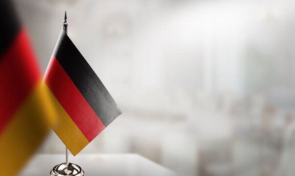 Small flags of the Germany on an abstract blurry background