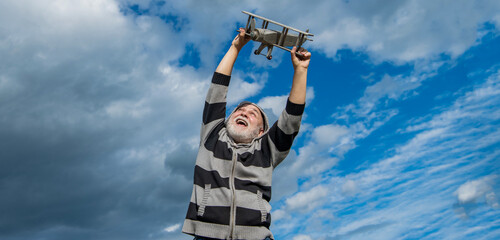 happy retirement. carefree granddad with toy. retired old man outdoor. senior man at retirement
