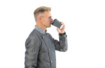 Side view of serious business man businessman boss in coat drinking coffee during coffee break
